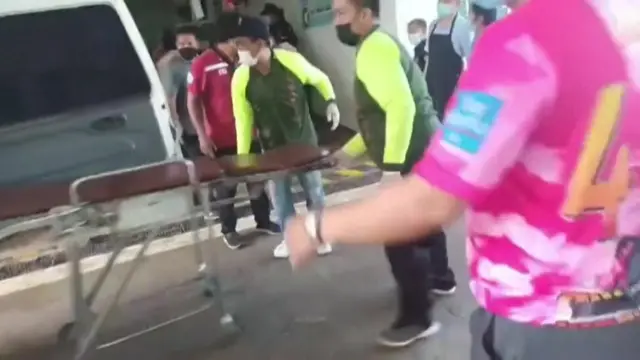 People with stretchers at the nursery that was attacked