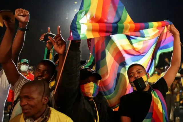 Supporters of the African National Congress (ANC) sing as they hold the LGBTQ flag during the launch of an election manifesto at the church square in Pretoria, South Africa, September 27, 2021.
