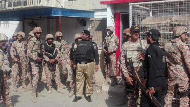 Pakistani security forces stand outside the Chinese consulate in Karachi
