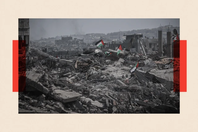 Palestinian flags are seen among the rubble of destroyed buildings