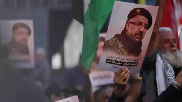 Hezbollah supporters hold up portraits of slain commander Fuad Shukr during his funeral in the southern suburbs of the Lebanese capital Beirut on 1 August 2024