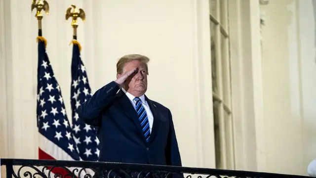 Trump salutes the departing Marine One helicopter