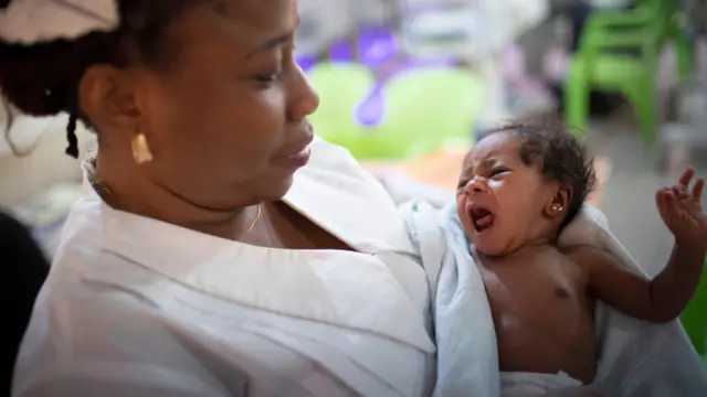 Onye nọọsụ kuu nwata a mụrụ ọhụrụ na-ebe akwa.