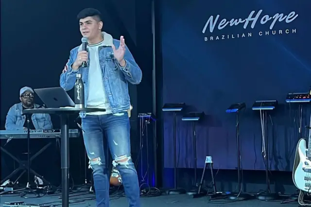 Lucas fala em um palco de igreja 