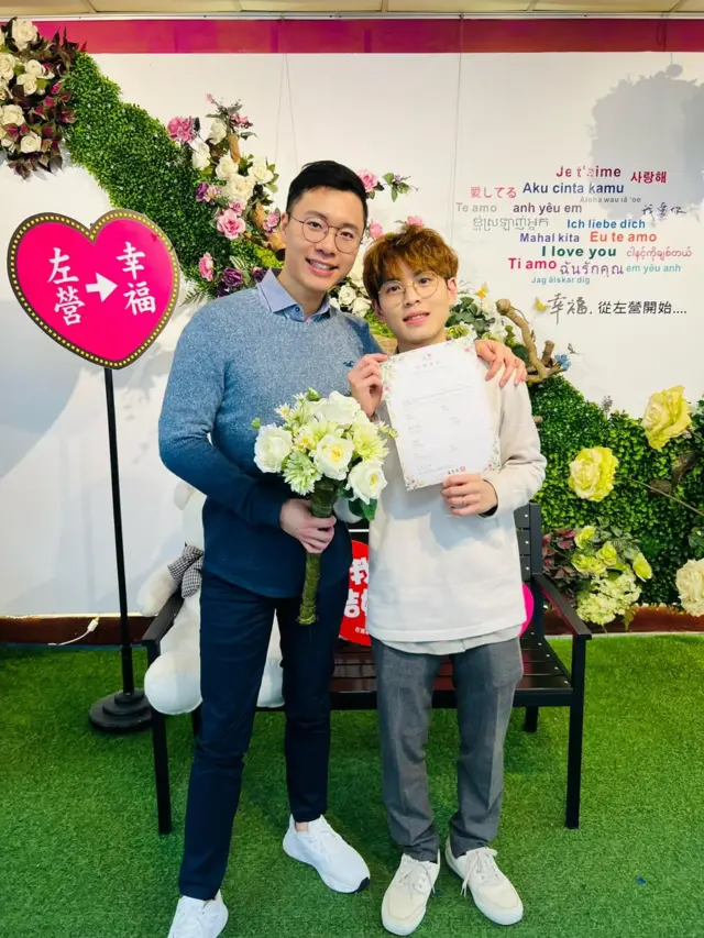 陈先生（左）及其同性伴侣在台湾注册结婚。