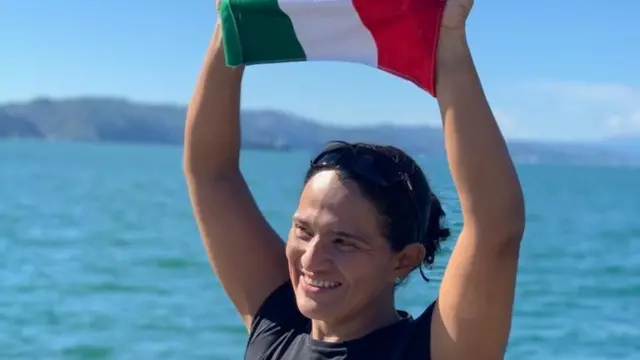 Nora sostiene la bandera de mexico