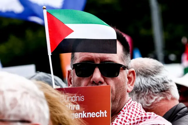 یک حامی فلسطینی که پرچم را روبروی صورتش گرفته است