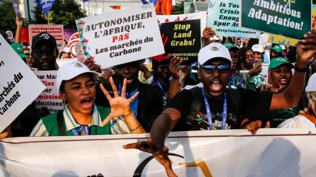 متظاهرون يحملون لافتات 