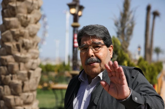 صالح مسلم، رئیس مشترک پیشین پ‌ی‌د، دستش را بالا آورده