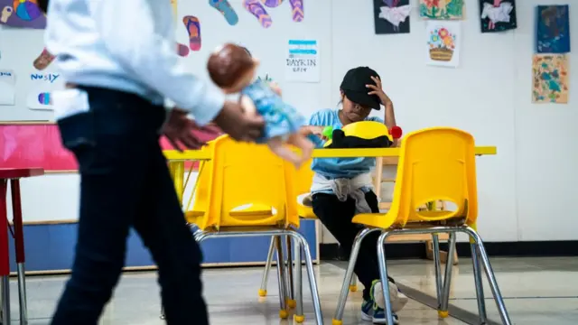 A girl is sitting in one of the classrooms at the South Texas Family Residential Center in 2019.