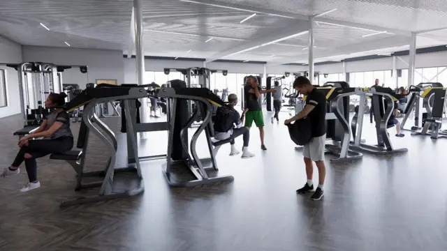 Imagen generada por computadora de un gimnasio, con varios asistentes sentados o de pie cerca de las máquinas. Las ventanas se alinean en la pared trasera y derecha.