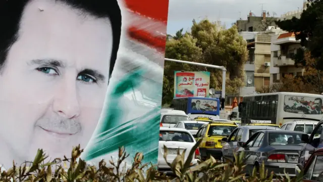 A photo taken on March 4, 2015 shows a banner bearing a portrait of Syrian President Bashar al-Assad in a street in the city of Damascus.
