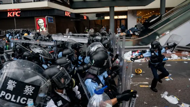 A police officer throws a teargas canister during a protest on June 12, 2019 in Hong Kong China