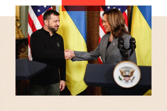 Volodymyr Zelensky and Kamala Harris shake hands on a stage in front of the Ukrainian flag and the US flag