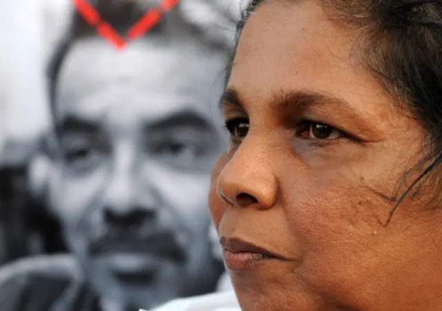 Sandhya Eknaligoda wife of missing Sri Lankan cartoonist and journalist Prageeth Eknaligoda holds up a placard bearing his image during a protest rally in Colombo on January 24, 2012. Prageeth Eknaligoda disappeared on January 24, 2010, just hours before the presidential election. Rights groups have repeatedly accused the government of stifling media freedoms, a charge denied by the authorities