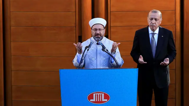 Turkish President Recep Tayyip Erdogan (R) stands next to the President of Religious Affairs of Turkey Ali Erbas
