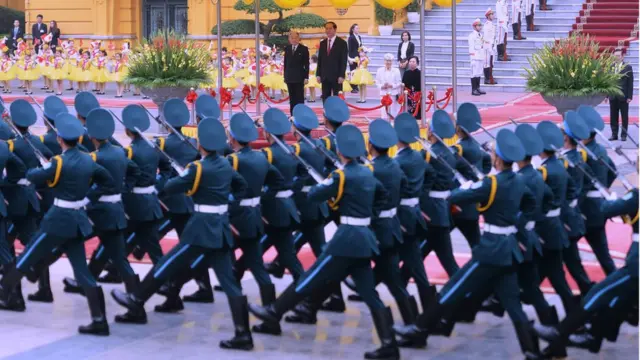Japan's Emperor Akihito (L) and Vietnamese President Tran Dai Quang watch honour guards march during an official welcoming ceremony at the presidential palace in Hanoi on March 1, 2017. Japan's emperor and empress departed February 28 for their first trip to Vietnam to meet families of former Japanese soldiers to help heal wounds left over from its occupation of the country during World War II