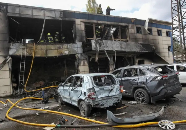 Зруйнована вибухом двоповерхова будівля та припарковані автомобілі