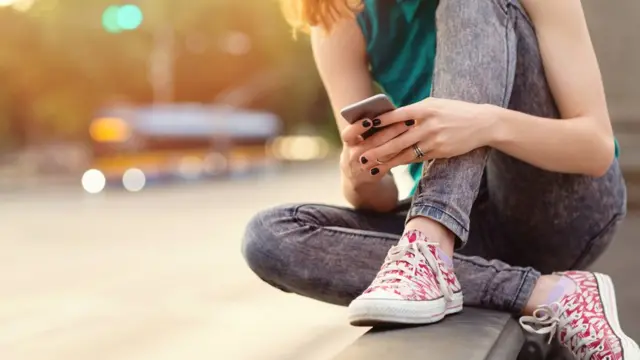 Adolescente usando o telefone