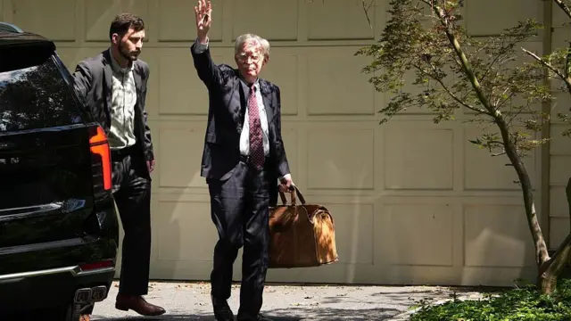 जॉन बोल्टन मैरीलैंड स्थित अपने घर के बाहर 