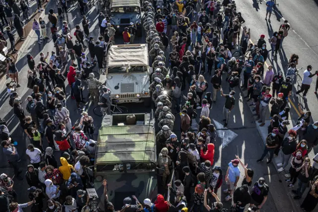 5. Demonstrators surround a cordon of Minnesota National Guardsmen during protests resulting from the killing of an unarmed black man, George Floyd, by police.