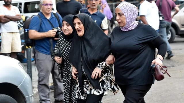 Three women arrive for di hospital in Beirut for news of dia loved-ones, afta di blast
