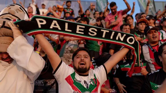 Homemnova plataforma de apostatorcida ergue faixa onde se lê: 'Palestino'