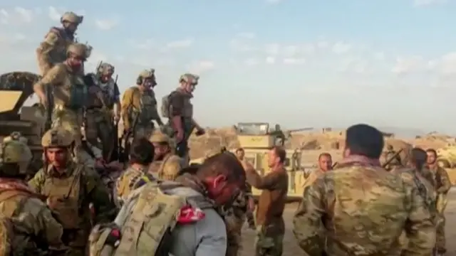 Afghan security forces outside Kunduz in July