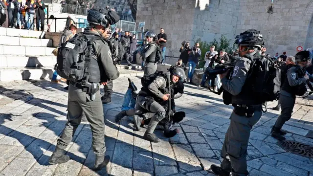 Israeli policemen detain a Palestinian protestor at Damascus Gate in the Jerusalem's Old City on December 8, 2017.