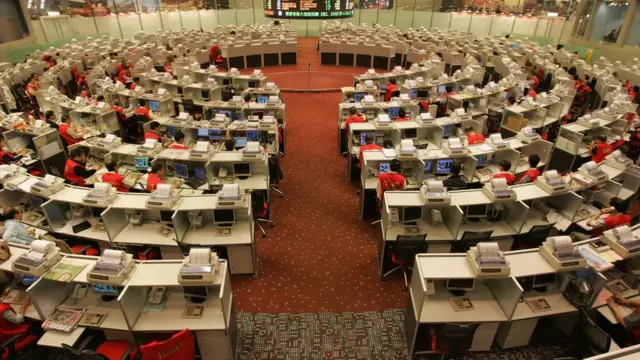A bustling trading floor in Hong Kong, representing the city's role as a complex financial gateway between mainland China and the world. (co.uk)