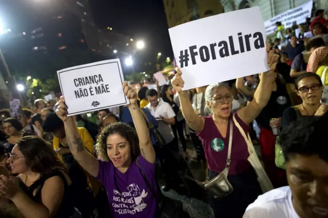 Mulheres segurando cartazesbet365 como baixarprotesto à noite