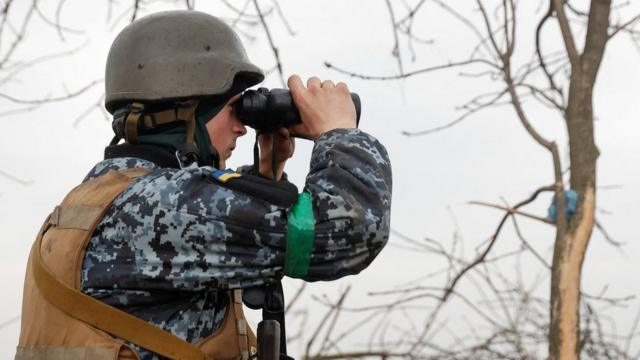 Soldado ucraniano usa binoculares en la región de Donetsk.