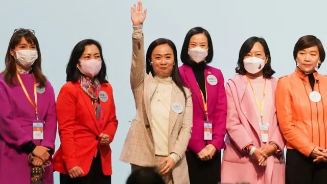 Candidates from the Election Committee constituency wave onstage after winning