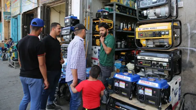An Iraqi man shops at a store selling power generators in Baghdad