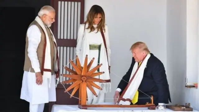 Mr and Mrs Trump tried their hand at spinning cloth, while Mr Modi (left) looked on