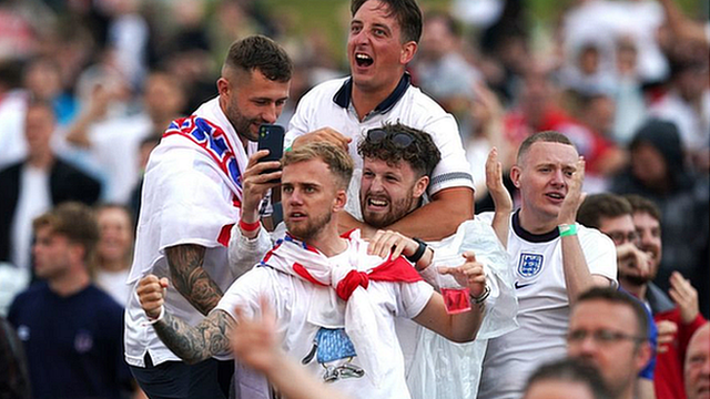 Fans in Manchester react after Manchester United's Harry Maguire scores England's second goal