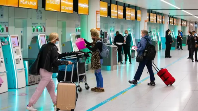 Passengers check in for the first holiday and leisure flight to take-off at Gatwick Airport, as easyJet relaunch flights from the UK to green-lit destinations today, for the first time this year
