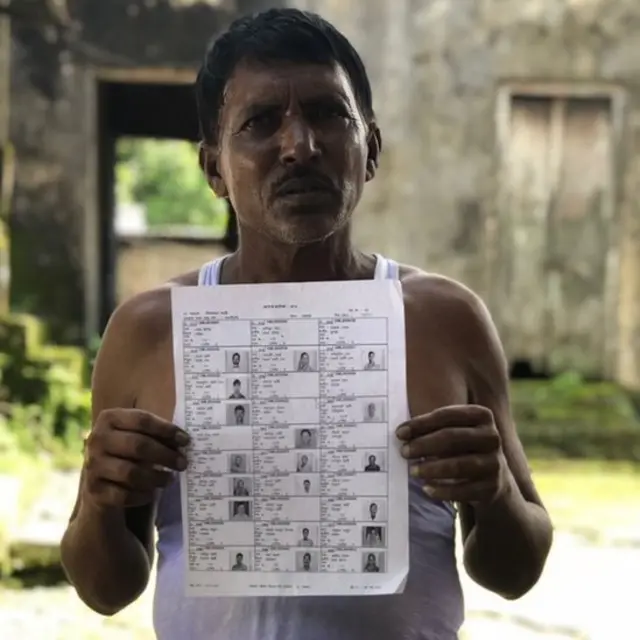 A villager holding up a draft list