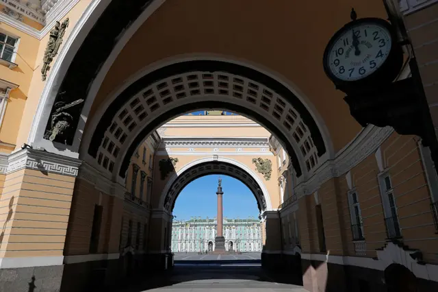 A clock showing the time at noon by The State Hermitage museum in front of Palace square in Saint Petersburg, Russia