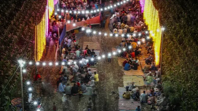 Guests gather between corn fields to attend a traditional wedding celebration in the village of Shamma in Egypt's northern Nile Delta province of Menoufia on August 21, 2020.