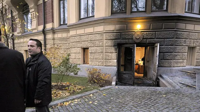 Unidentified officials stand on October 21, 2008 outside the Turkish Embassy in Helsinki after the door of the building was set ablaze around 3:00 am (0000 GMT), though the fire was quickly detected by a police patrol and extinguished. Finnish police have detained four men suspected of trying to set embassy on fire.