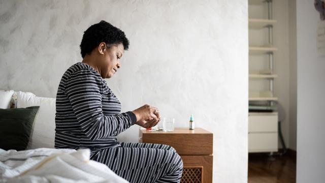 Mulherroyal panda cassinopijama tomando remédio no quarto