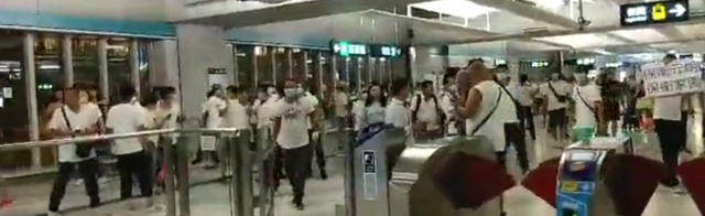 Men in white T-shirts at Yuen Long