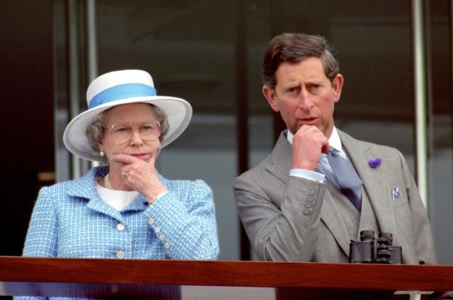 Queen Elizabeth II and the Prince of Wales appearing thoughtful as they watch the races at Epsom