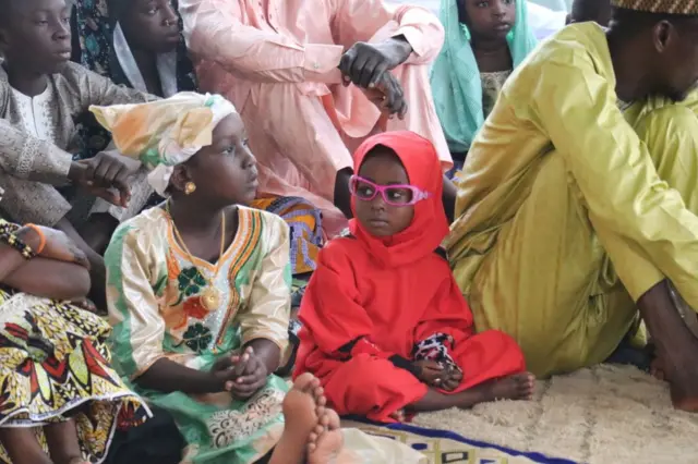 A family dressed in different colours attend prayers at the Central Mosque in Cameroon's capital, Yaoundé.