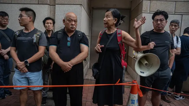 Members of the League of Social Democrats (LSD) protest outside the West Kowloon Magistrates' Courts during a verdict for 47 pro-democracy activists in Hong Kong, China, 30 May 2024. A court in Hong Kong on 30 May convicted 14 defendants over 'conspiracy to subvert the state power' under the national security law, while two were acquitted, in trial of 47 prominent pro-democracy figures in Hong Kong arrested and charged in 2021.