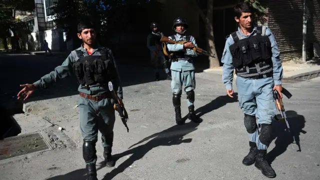 Afghan security personnel patrol near the site of an attack on a charity in central at the Shar-e-Naw in Kabul on 6 September