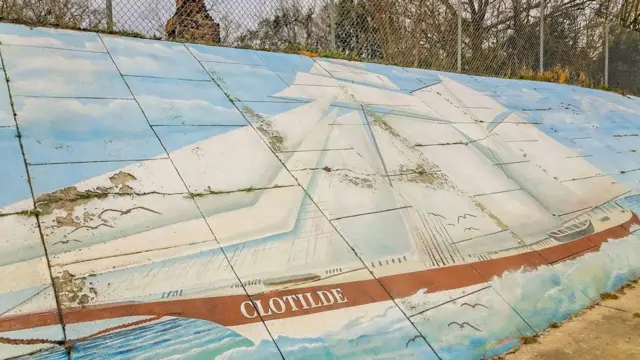 Une peinture murale représentant le navire négrier Clotilda longe l'autoroute qui sépare les deux côtés d'Africatown