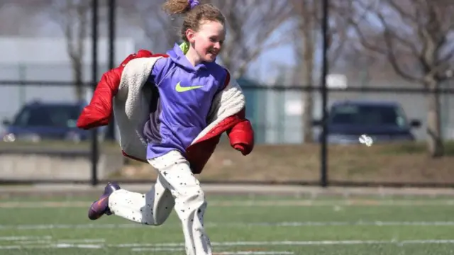 Niña jugando sobre el césped.