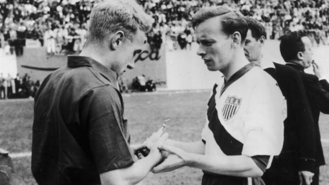 The captains of England and USA, Billy Wright and Ed McIlvenny (right) exchange souvenirs at the start of their match on June 29, 1950 in Belo Horizonte